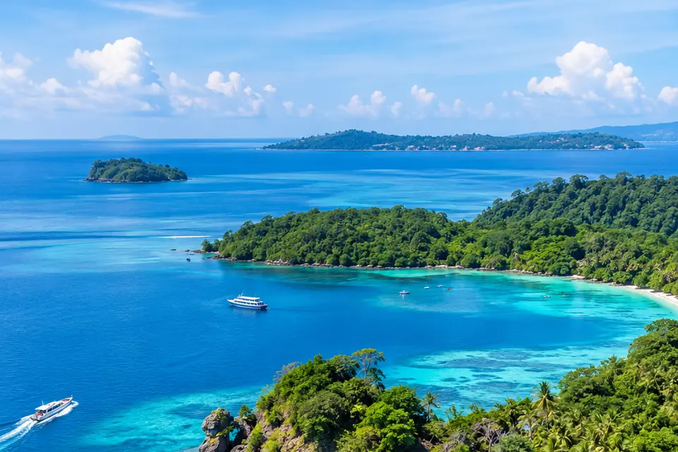 Aerial view of forested islands and turquoise water in the Andamans