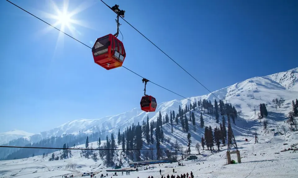 Red cable cars over a snowy slope